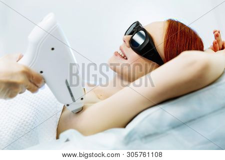 Young Woman Receiving Laser Hair Removal Epilation On Face. Laser Skin Care Concept