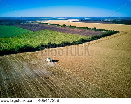 Aerial View On Combine Harvester Gathers The Wheat At Sunset. Harvesting Grain Field, Crop Season. V