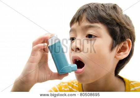 Little Boy Using Asthma Inhaler For Breathing On White Background