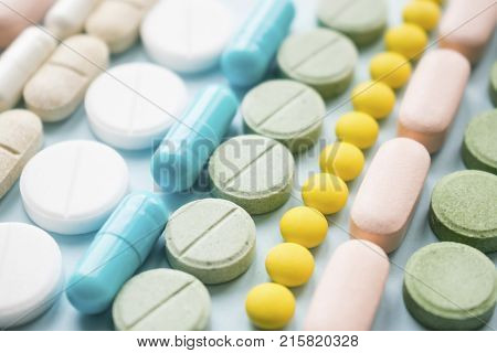 Opioid painkillers crisis and drug abuse concept. Opioid and prescription medication addiction epidemic. Different kinds of multicolored pills. Pharmaceutical medicament background