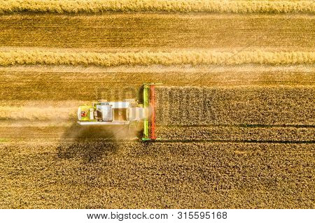 Harvesting Time. Agriculture. Agricultural Industry. Aerial View Of Combine Harvester In Field. Agri