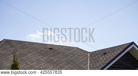 Brown Corrugated Metal Profile Roof Installed On A Modern House. The Roof Of Corrugated Sheet. Roofi