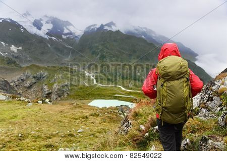 Hiking - hiker woman on trek with backpack living healthy active lifestyle. Hiker girl walking on hike in mountain nature landscape in Steingletscher, Urner Alps, Berne, Swiss alps, Switzerland.