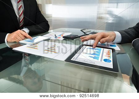 Two Businessman Working On Digital Tablet