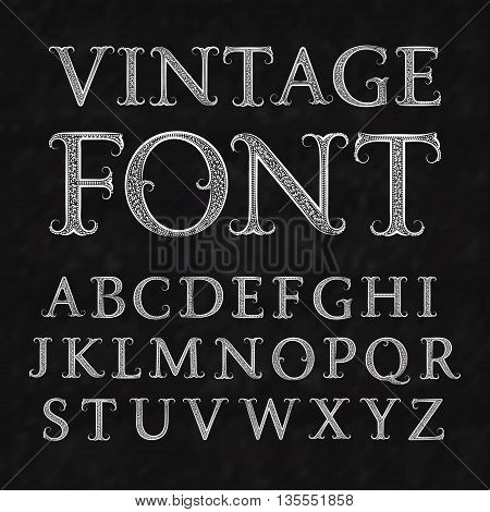 Vintage patterned letters. Vintage font in floral baroque style. Vintage latin alphabet. Vintage white capital letters on a black textured background.