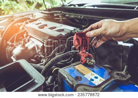 Maintenance Car. Hand Of Technician Checking Or Fixing Battery Terminals And Engine On The Car Elect