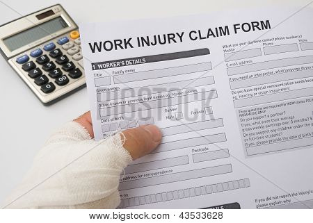 Hurted Hand Holding A Work Injury Claim Form