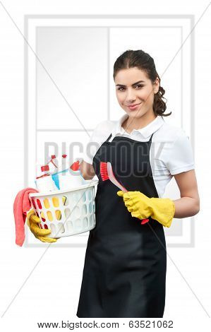 Portrait of cleaning lady holding a brush and a basket