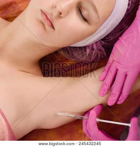 Doctor Making Intramuscular Injections In Armpit Against Hyperhidrosis