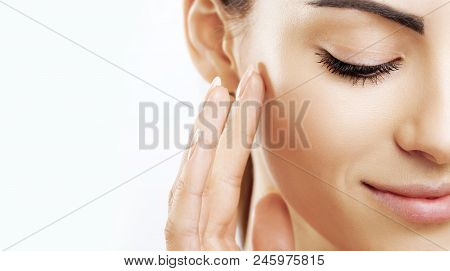 Closeup Happy Young Woman Applying Cream To Her Face Skincare And Cosmetics Concept. Cosmetics. Woma