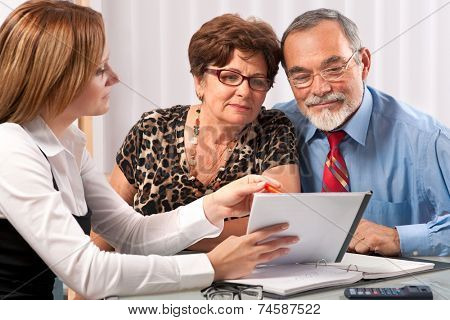 Senior couple meeting with agent or advisor