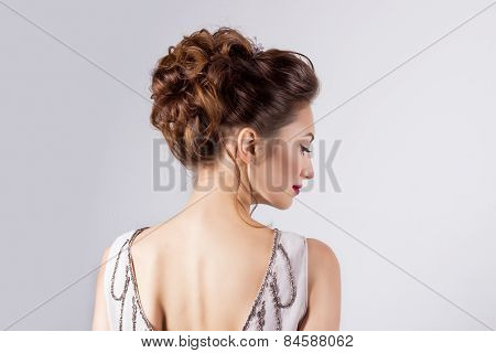 beautiful young girl in the image of the bride, beautiful wedding hairstyle with flowers in her hair