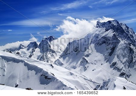 Winter Mountains With Snow Cornice And Blue Sky With Clouds In Nice Sun Day