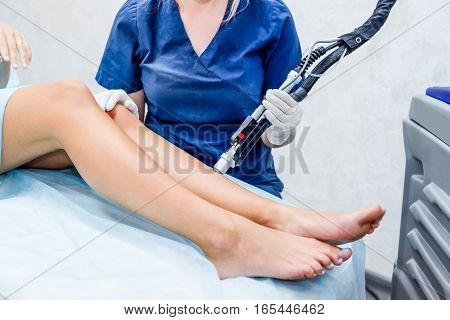 Close Up Laser Hair Removal In The Beauty Salon. Woman Having Legs Epilation. Laser Hair Removal Equ