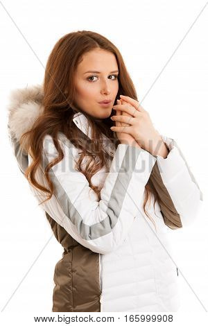 Beautiful Young Woman In Winter Jacket  Blowing In Her Ahnds Feeling Cold Isolated Over White