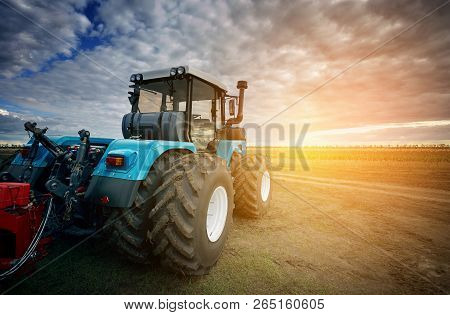 Tractor Working On The Farm, A Modern Agricultural Transport, A Farmer Working In The Field, Tractor