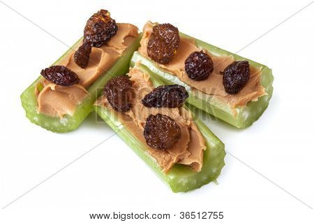 Ants on a log, celery with peanut butter and raisins, isolated on white.  Healthy snacks.