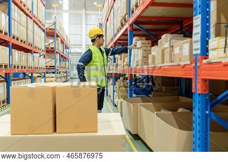 Asian Male Factory Manager Inspect Goods In Warehouse Or Inventory And Check Stock Product. Transpor