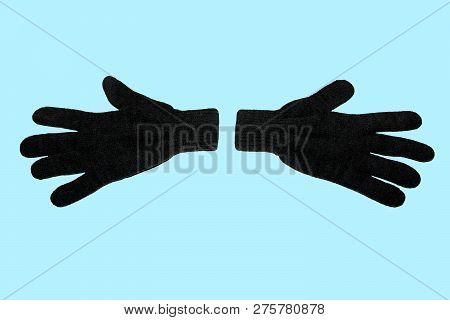 A Pair Of Grey Winter Knitted Gloves. Horizontally. On A Blue Background. The View From The Top. Iso