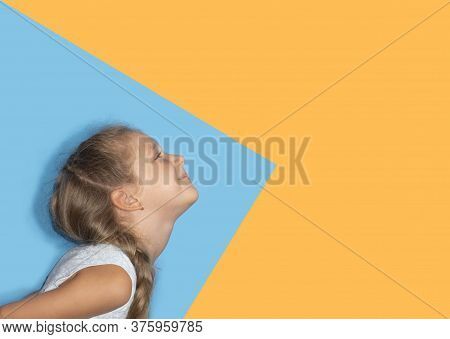 Laughing Cute Girl Portrait In Profile. Funny Child Isolated On Colorful Background