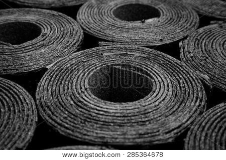 Closeup of Rolls of new black roofing felt or bitumen. Shallow depth off field