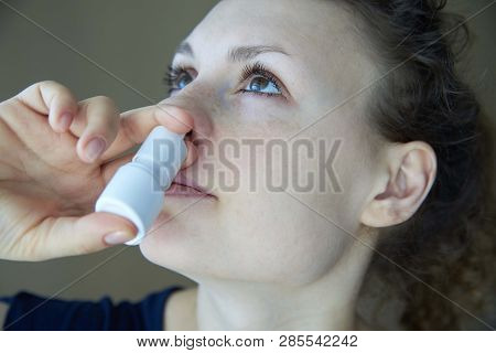 Sick Girl Sprays The Spray From Runny Nose Into The Nasal Pass