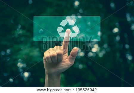 Hand pressing button ecology interface with arrow recycling. Hand pressing recycling symbol on button touch screen. Environmental concept recycle.