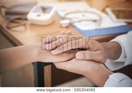 Doctor's Hands Holding Female Patient Hand For Reassuring With Friendly Encouragement Empathy For Ho