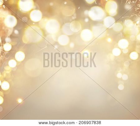 Christmas glowing Golden Background. Christmas lights. Gold Holiday New year Abstract Glitter Defocused Background With Blinking Stars and sparks. Blurred Bokeh