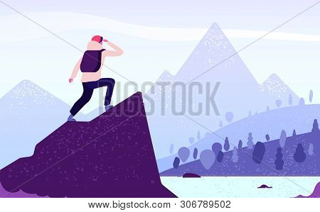 Man In Mountain Adventure. Climber Standing With Backpack On Rock Looks To Mountain Landscape. Touri