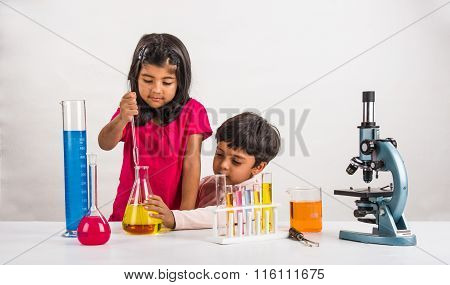 4 year old indian boy and girl doing science experiment, science Education. asian kids and science e