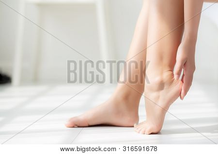 Closeup Beautiful Young Asian Woman Applying Cream And Lotion Onto Foot Dry On Bed, Beauty Asia Girl