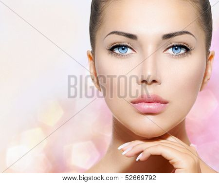 Beauty Portrait. Beautiful Spa Woman Touching her Face. Perfect Fresh Skin. Pure Beauty Model Girl. Youth and Skin Care Concept