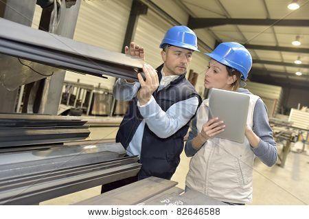 Supplier with engineer checking on production in factory