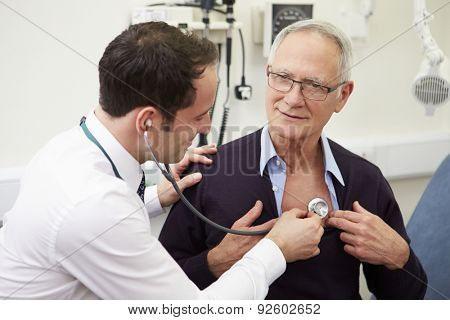 Doctor Examining Senior Male Patient In Hospital