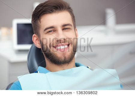 Portrait Of Happy Patient In Dental Chair.