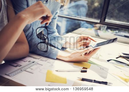 Successful Account Managers Team Analyze Business Reports Modern Interior Design Loft Office.Coworkers Using Contemporary Tablet.Sharing Information.Blurred Background.New Startup Idea Process