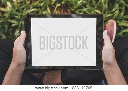 Asian Woman Sitting And Holding Black Tablet With Blank White Screen. Using Tablet Shopping Payment 