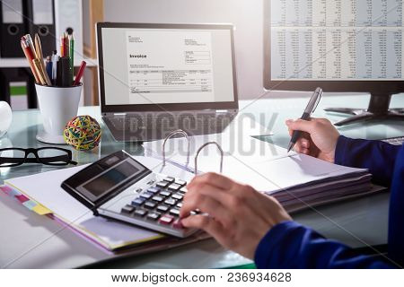 Businessperson Calculating Invoice