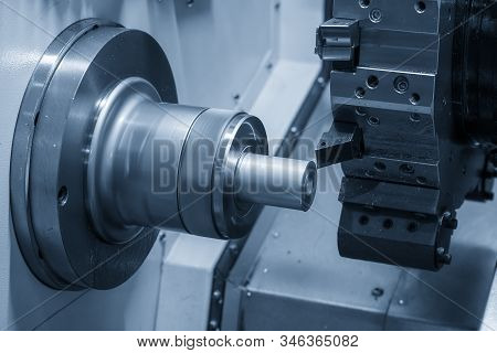 The Cnc Lathe Machine In Metal Working Process Cutting The Metal Shaft Parts With In The Light Blue 