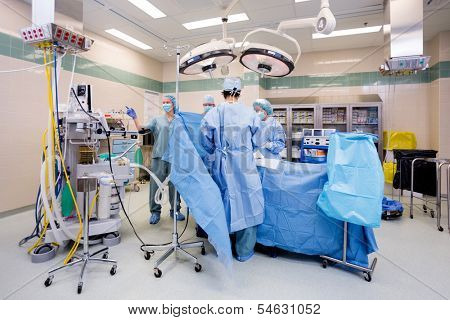 Surgical team operating on patient in theater in hospital