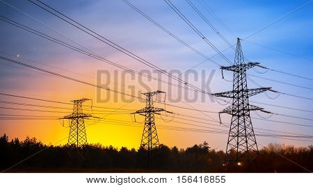 Electrical pylon and high voltage power lines at night