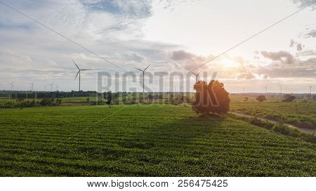 Windmills For Electric Power Production On Sunset