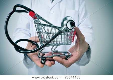 doctor holding in his hand a shopping cart with a stethoscope inside, depicting the health care industry concept