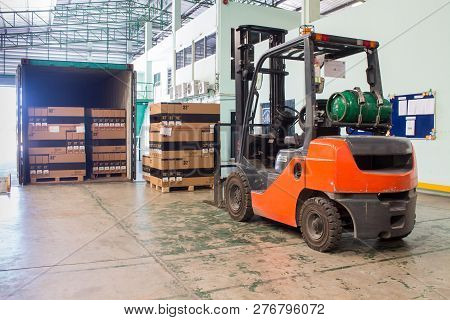 The Forklift Loading Pallet With A Forklift Into A Truck.