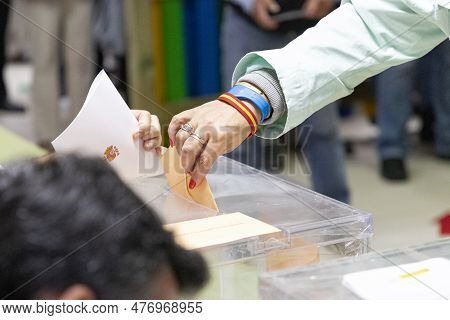 Elections. Hand Of A Person Who Votes At The Polls During The Elections. Envelope With The Ballot On