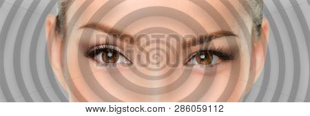 Hypnosis spiral over eyes of woman hypnotized closeup banner panorama. Asian girl portrait background.