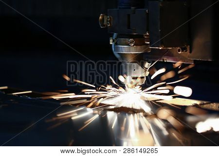 Sparks Fly Out Machine Head For Metal Processing Laser Metal On Metallurgical Plant Background. Manu