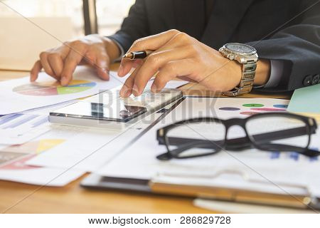 Businessman Or Accountant Working On Calculator To Calculate Business Data Concept. Accounting,inves