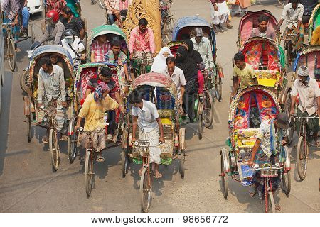 Rickshaws transport passengers in Dhaka, Bangladesh.